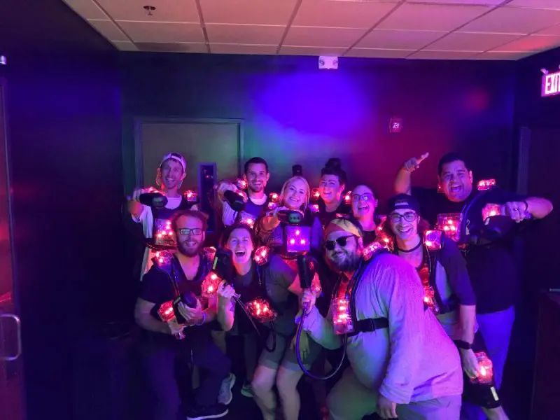 CRC students holding lights in a dimly lit room